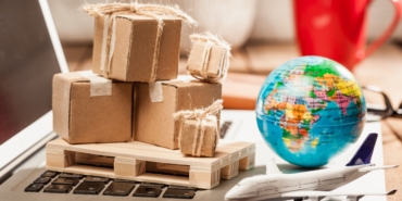 Carton boxes on computer as online shopping logistics concept