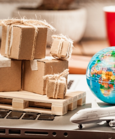 Carton boxes on computer as online shopping logistics concept
