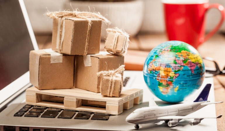 Carton boxes on computer as online shopping logistics concept