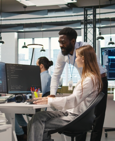 Startup office manager congratulates young girl after developing AI models